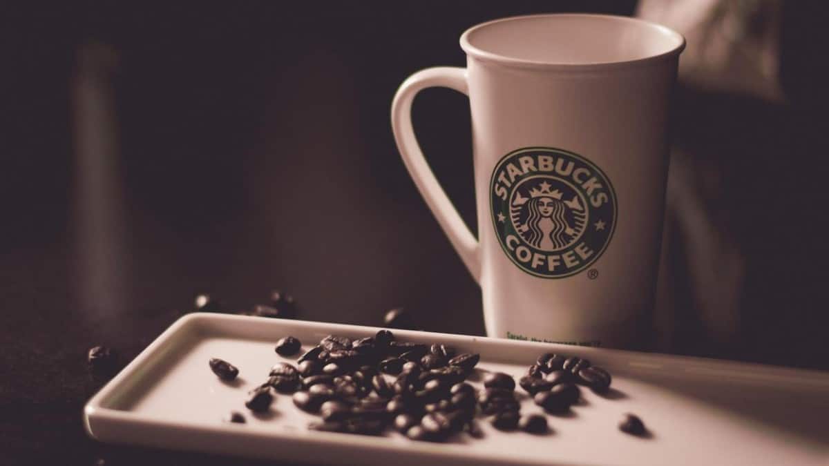 The most popular brand Starbucks coffee along with coffee beans on a tray.