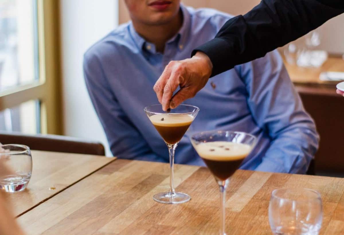 A man being served coffee liqueur. 