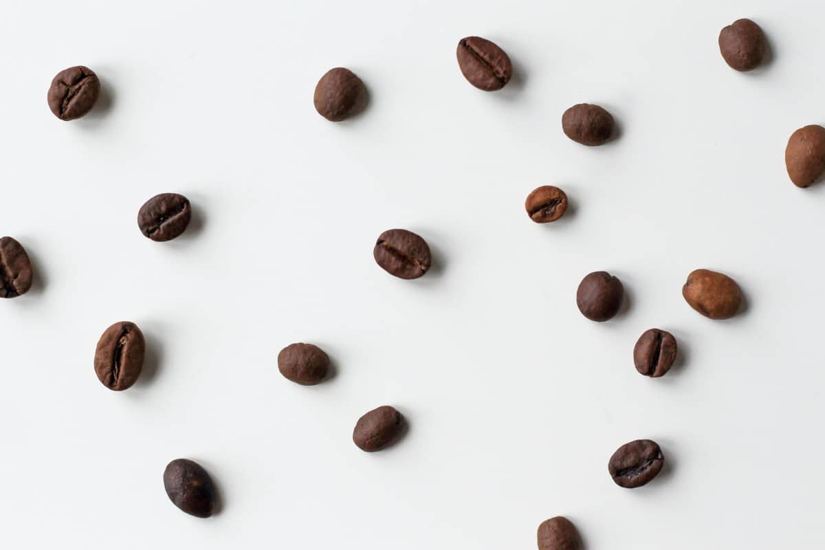 scattered coffee beans on a white background