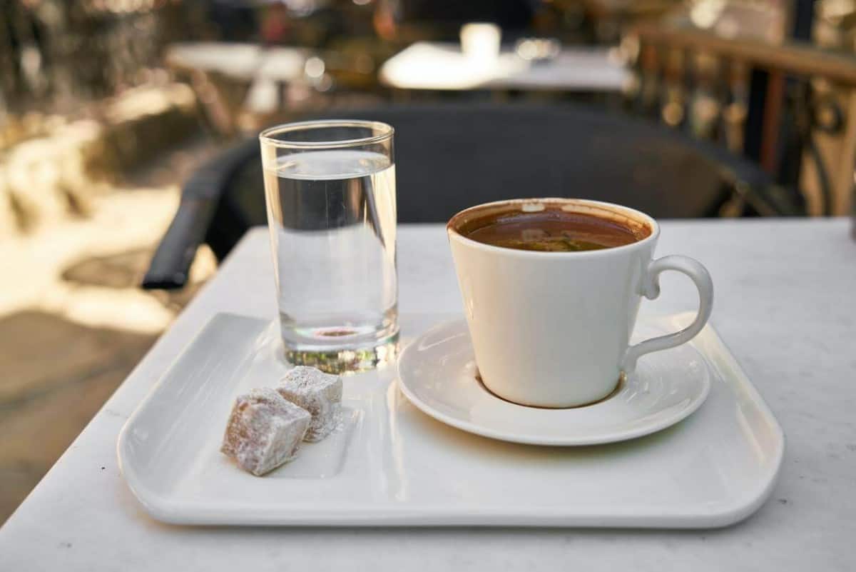 cup of coffee next to a glass of water