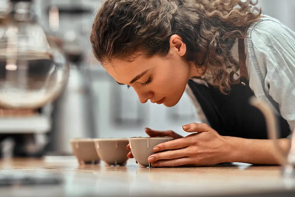 A female Q grader is testing the coffees
