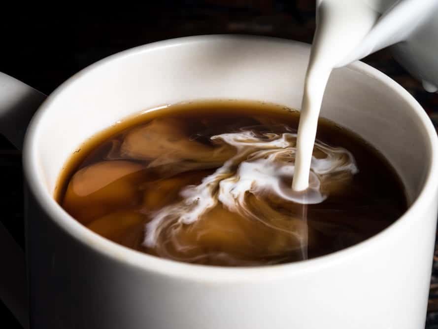 Milk swirling smoothly in a cup of espresso.