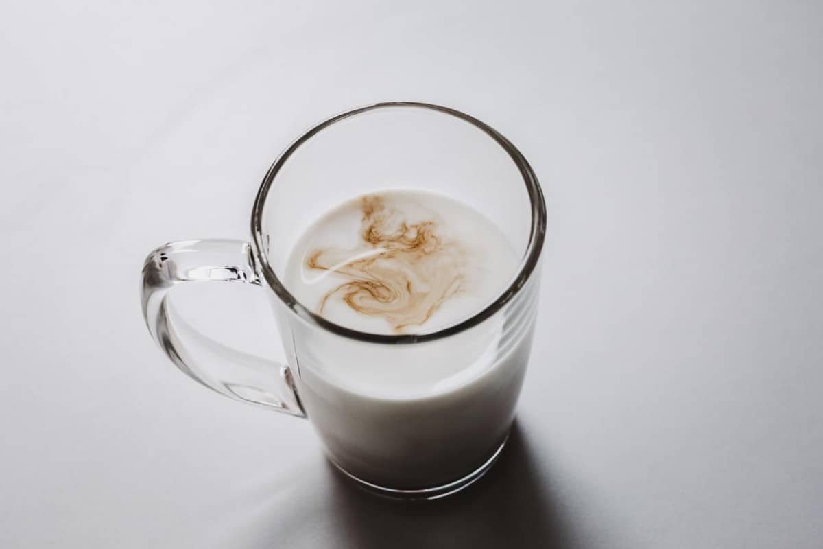 milk in a glass cup with traces of coffee