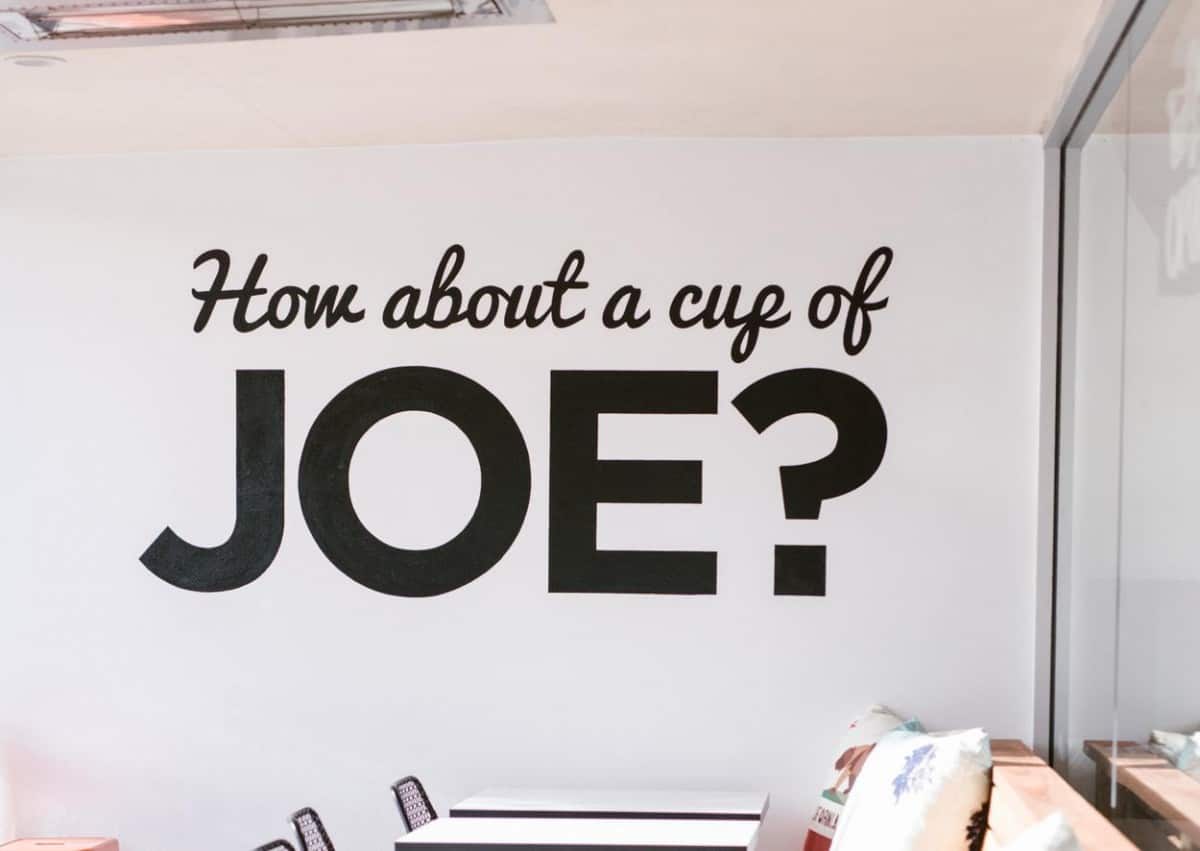 a white wall with the words 'how about a cup of Joe?' on it
