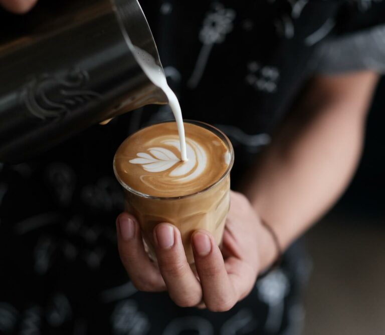 Pouring milk over flat white