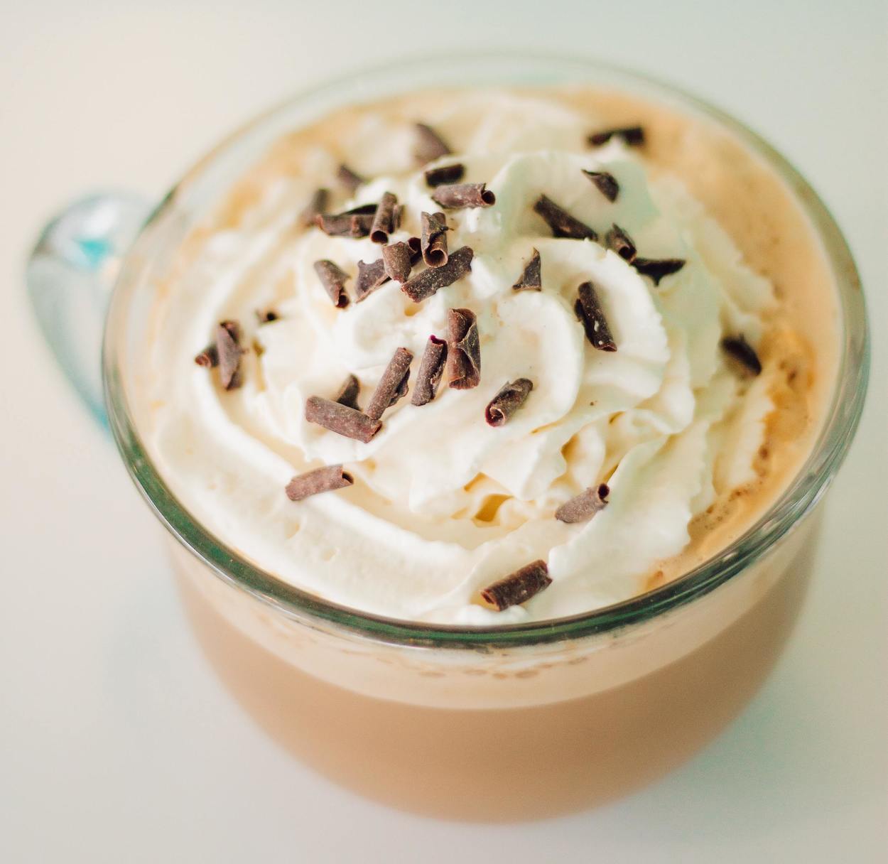 A tempting mug of mocha with whipped cream on top.
