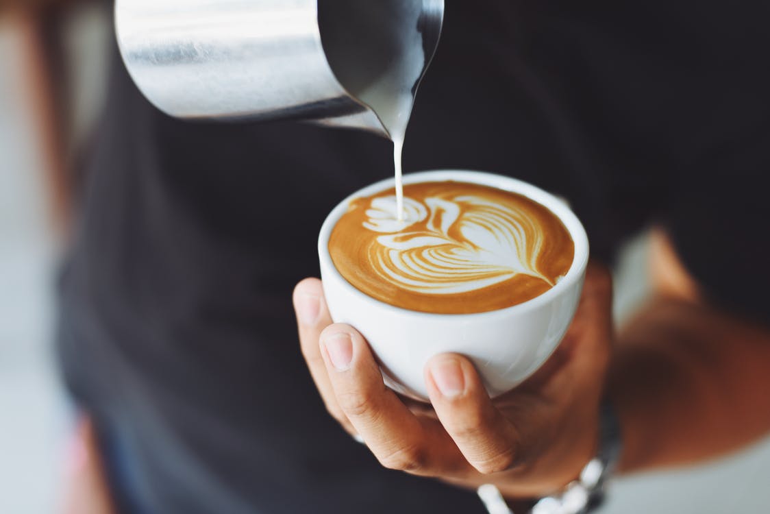 A barista creating latte art.