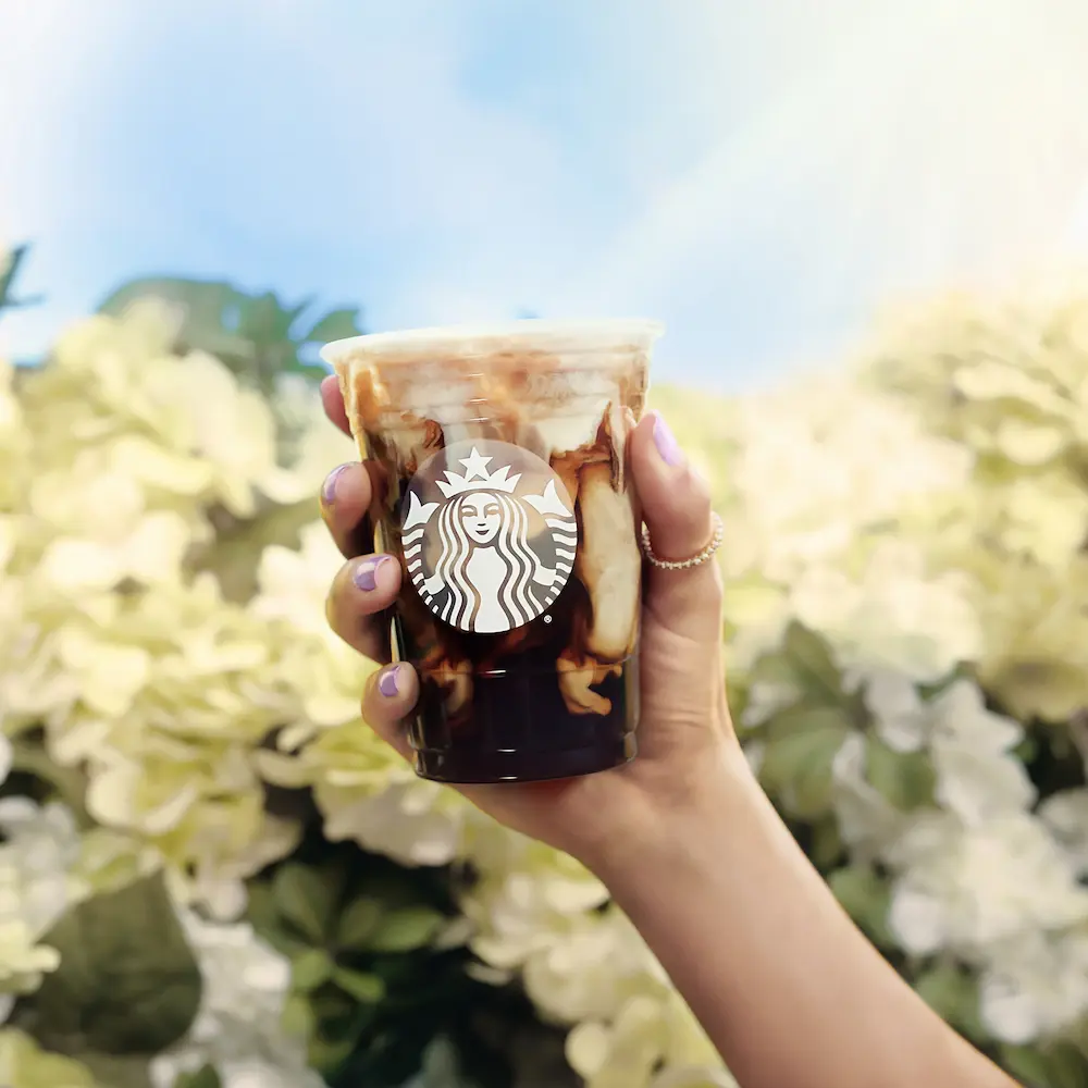 Woman holding a Starbucks iced shaken espresso