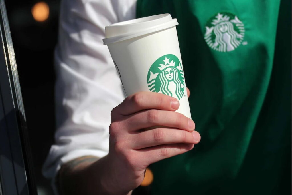 Starbucks barista holding a cup