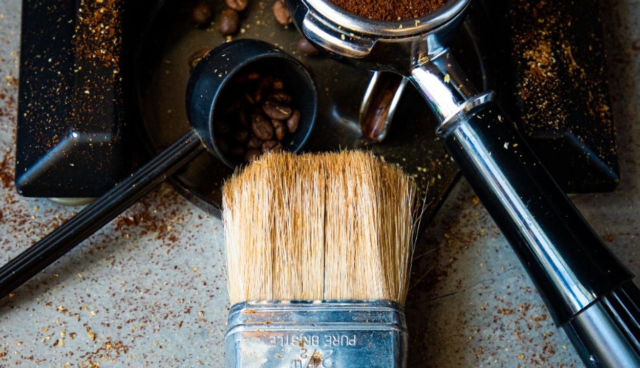 Paint brush placed with coffee beans.