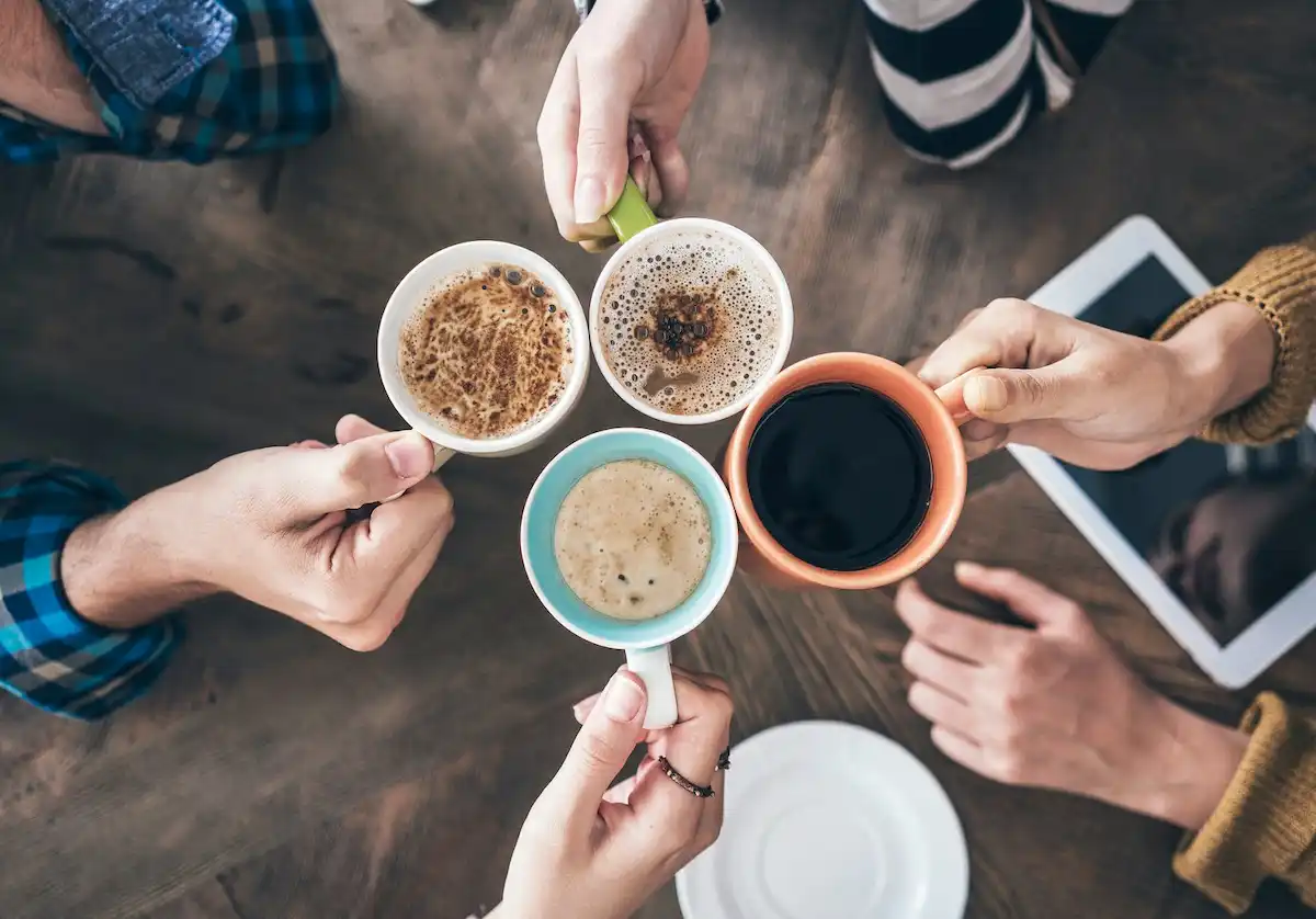 Four people celebrating national coffee day
