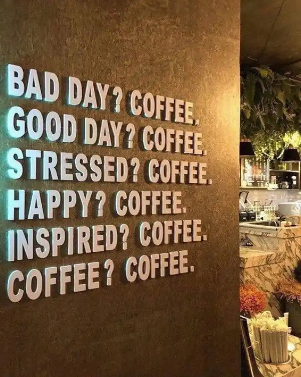 Inspirational coffee quote written on a wall